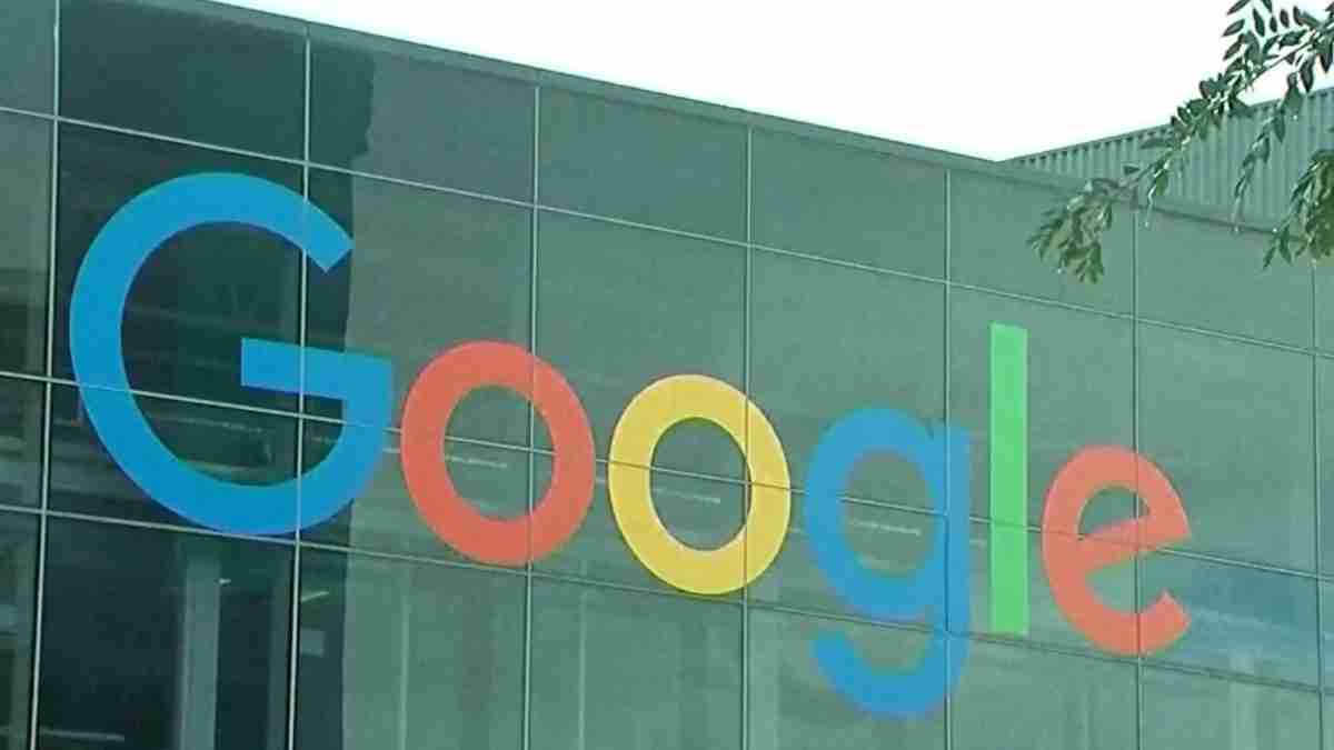Google logo letters in blue, red, yellow, and green on a glass building facade.