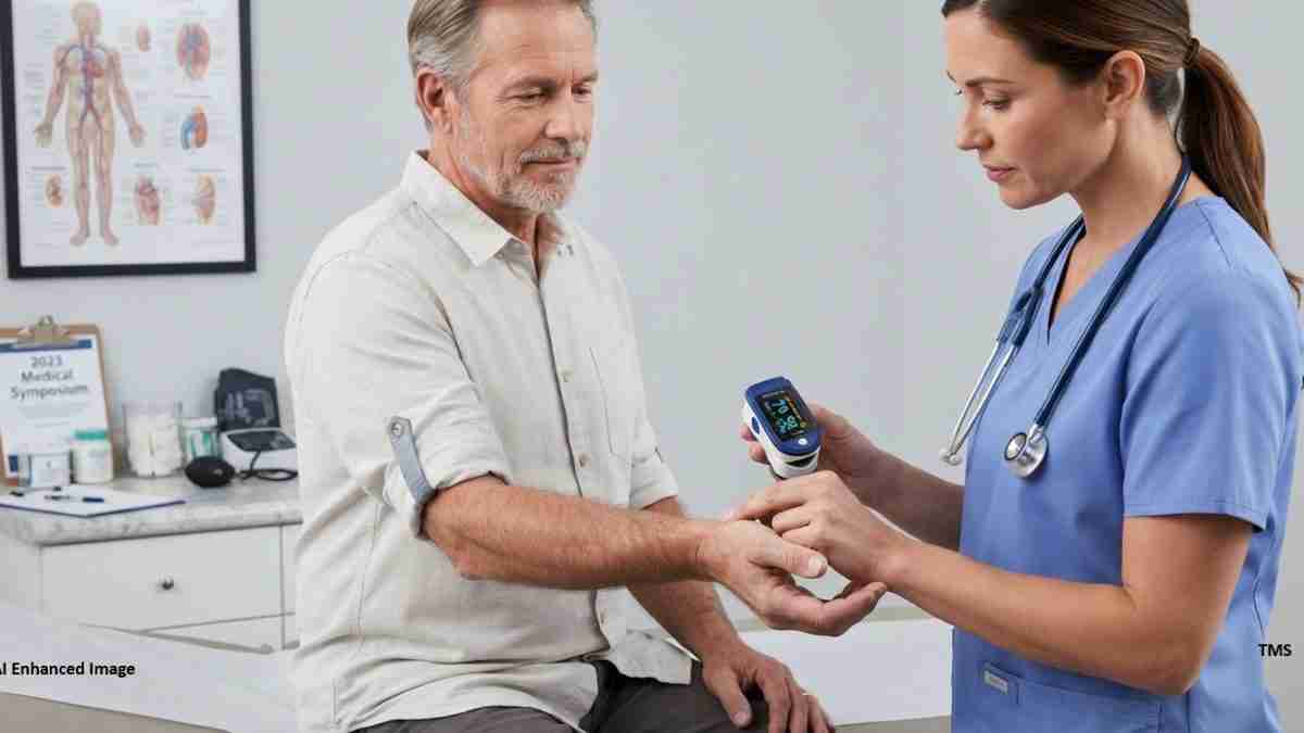 Nurse in blue scrubs checks a patient’s vitals using a handheld device while a blood pressure cuff is placed on his arm.