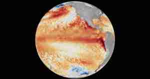 Global map showing sea surface temperature anomalies with warm orange-red bands across the oceans on a black background Earth image